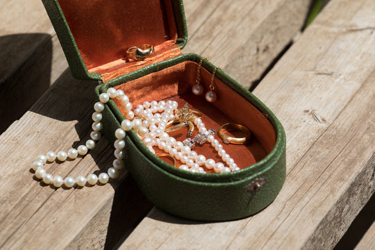 Pearl necklace kept in a jewelry box with a separate compartment for pearls longevityy